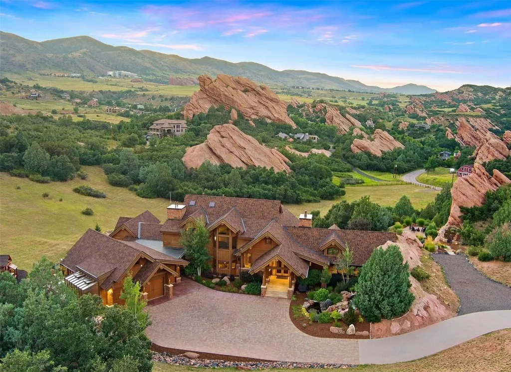 9411 South Cougar Road Home in Littleton, Colorado. Discover a breathtaking masterpiece nestled in the foothills west of Denver, where traditional log home style meets the awe-inspiring red rock landscape. This 8,500-square-foot estate seamlessly blends into its surroundings, with hand-peeled logs, reclaimed barnwood flooring, and modern elements. 