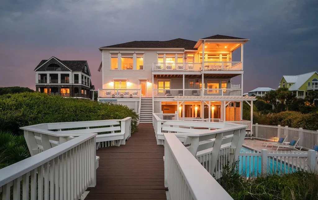 9721 Dolphin Ridge Road Home in Emerald Isle, North Carolina. Discover the epitome of oceanfront living in this exquisite Dolphin Ridge home, where luxury and customization intertwine to create a one-of-a-kind island sanctuary. Immerse yourself in the coastal lifestyle as you step into this beautifully furnished abode, thoughtfully tailored by the builder/owners to offer a seamless blend of comfort and sophistication.