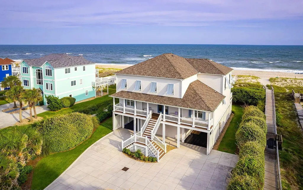 9721 Dolphin Ridge Road Home in Emerald Isle, North Carolina. Discover the epitome of oceanfront living in this exquisite Dolphin Ridge home, where luxury and customization intertwine to create a one-of-a-kind island sanctuary. Immerse yourself in the coastal lifestyle as you step into this beautifully furnished abode, thoughtfully tailored by the builder/owners to offer a seamless blend of comfort and sophistication.