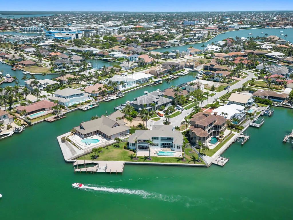 Nestled in prestigious Collier Bay on Marco Island, 960 Giralda Ct embodies coastal luxury living at its finest. With unobstructed bay views, this 2014-built, 4-bedroom, 5-bathroom home seamlessly combines opulence and coastal chic style.