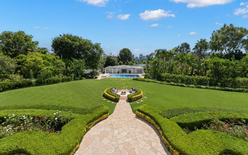 10250 West Sunset Boulevard Home in Los Angeles, California. Discover the epitome of luxury living at this meticulously reimagined Paul Williams designed estate in Holmby Hills, spanning approximately 2.8 acres. Comprising three structures with nearly 30,000 SF of living space, this world-class property offers unrivaled privacy, an expansive motor court, 14 bedrooms, 25 baths, and an array of amenities including a theater, game room, and a wellness-focused pool house. 
