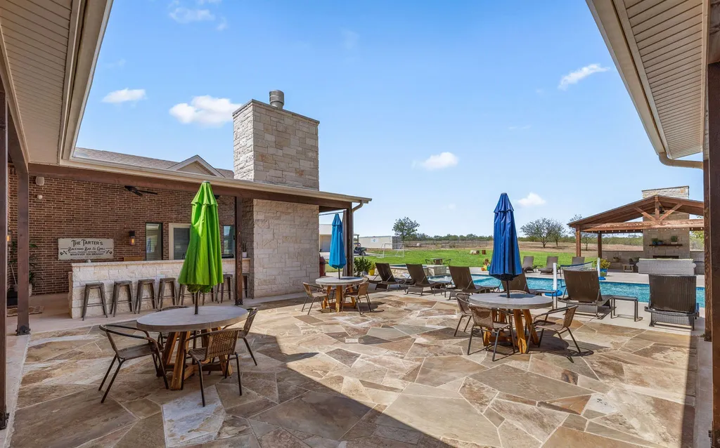 1134 Kinta Trial Home in Wichita Falls, Texas. Discover this unique 10-acre property in Clay County, featuring a stunning 6-bedroom home with 6.5 bathrooms, 6 fireplaces, a heated pool, outdoor kitchen, and even a catfish pond for fishing.