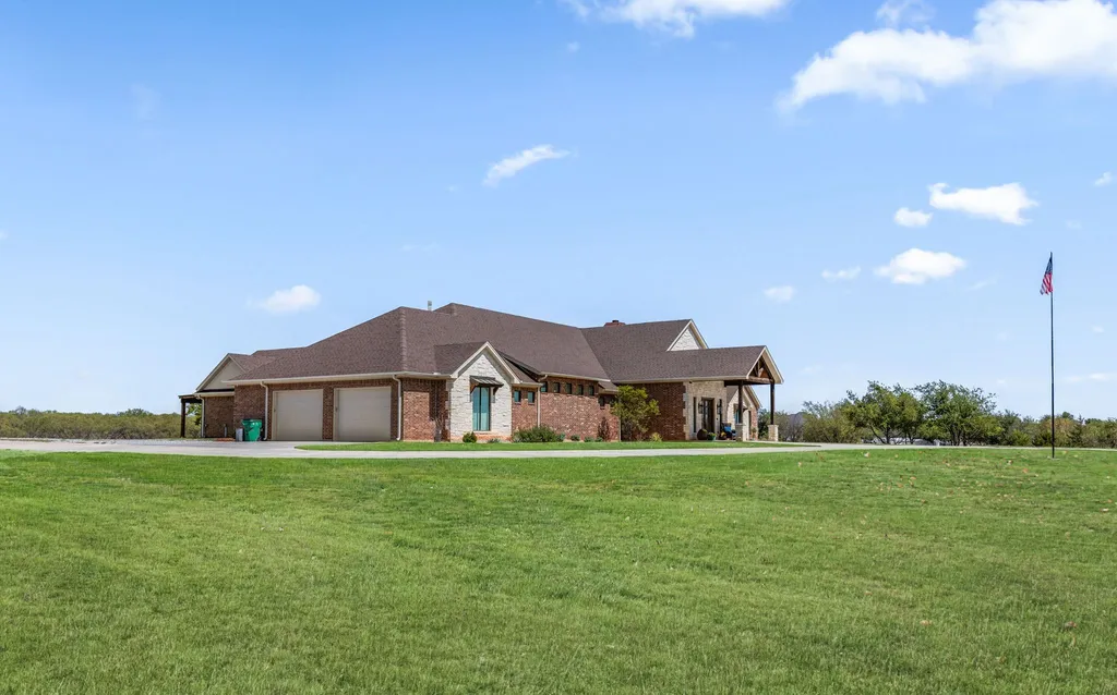 1134 Kinta Trial Home in Wichita Falls, Texas. Discover this unique 10-acre property in Clay County, featuring a stunning 6-bedroom home with 6.5 bathrooms, 6 fireplaces, a heated pool, outdoor kitchen, and even a catfish pond for fishing.