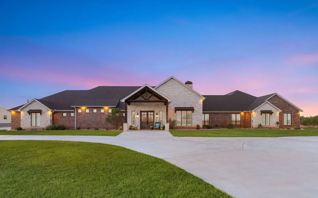 1134 Kinta Trial Home in Wichita Falls, Texas. Discover this unique 10-acre property in Clay County, featuring a stunning 6-bedroom home with 6.5 bathrooms, 6 fireplaces, a heated pool, outdoor kitchen, and even a catfish pond for fishing.