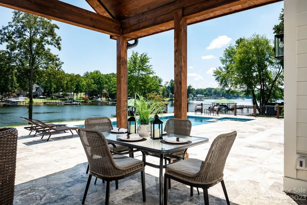 155 Riverwood Road Home in Mooresville, North Carolina. Experience the epitome of luxury in this new construction home on Lake Norman. Boasting 4 bedrooms, 4.5 bathrooms, a pool, dock, and breathtaking lake views, this home offers a lifestyle of comfort and elegance. 