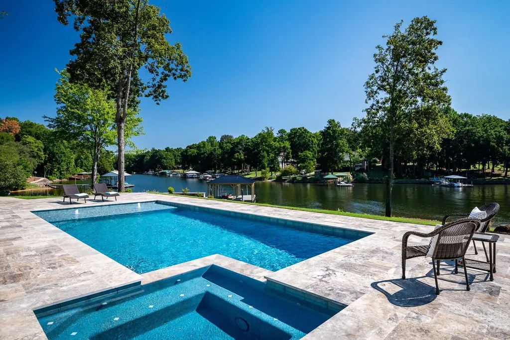 155 Riverwood Road Home in Mooresville, North Carolina. Experience the epitome of luxury in this new construction home on Lake Norman. Boasting 4 bedrooms, 4.5 bathrooms, a pool, dock, and breathtaking lake views, this home offers a lifestyle of comfort and elegance. 