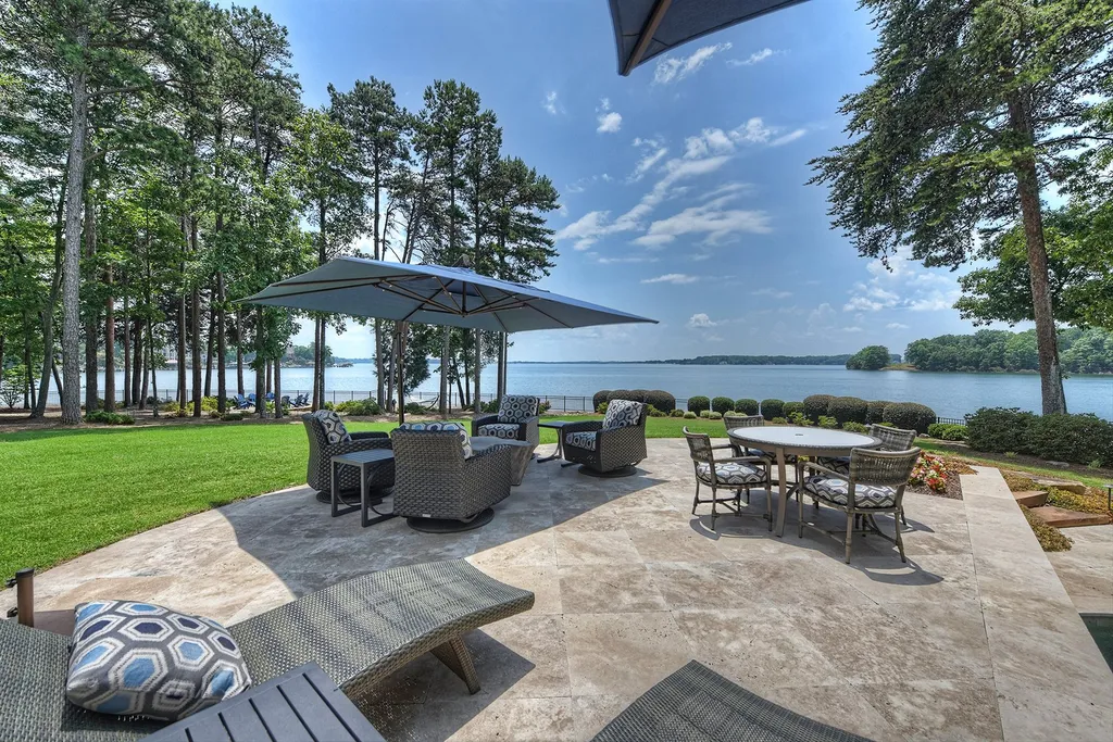 15503 Fishermans Rest Court Home in Cornelius, North Carolina. Experience timeless luxury in this private custom home within The Peninsula, offering breathtaking panoramic views of Lake Norman. Meticulously renovated to perfection, it features a gourmet chef’s kitchen, spacious living areas, a serene pool deck, and endless amenities. Enjoy exquisite sunrises and sunsets in this exceptional lakefront estate.