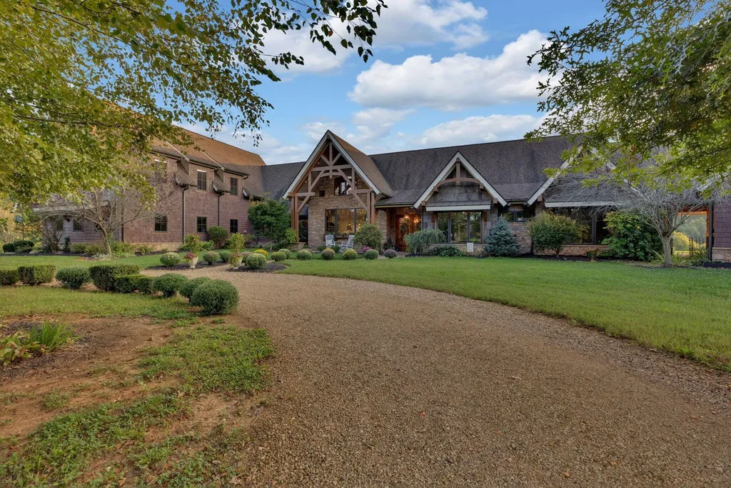 180 Riverwalk Court Home in Greeneville, Tennessee. Discover your dream oasis on this breathtaking 5-acre riverfront property! This extraordinary 7,000+ sqft home seamlessly blends transitional architecture with rustic charm, creating a captivating retreat. The striking blend of stone and poplar wood siding on the exterior exudes warmth and charm.