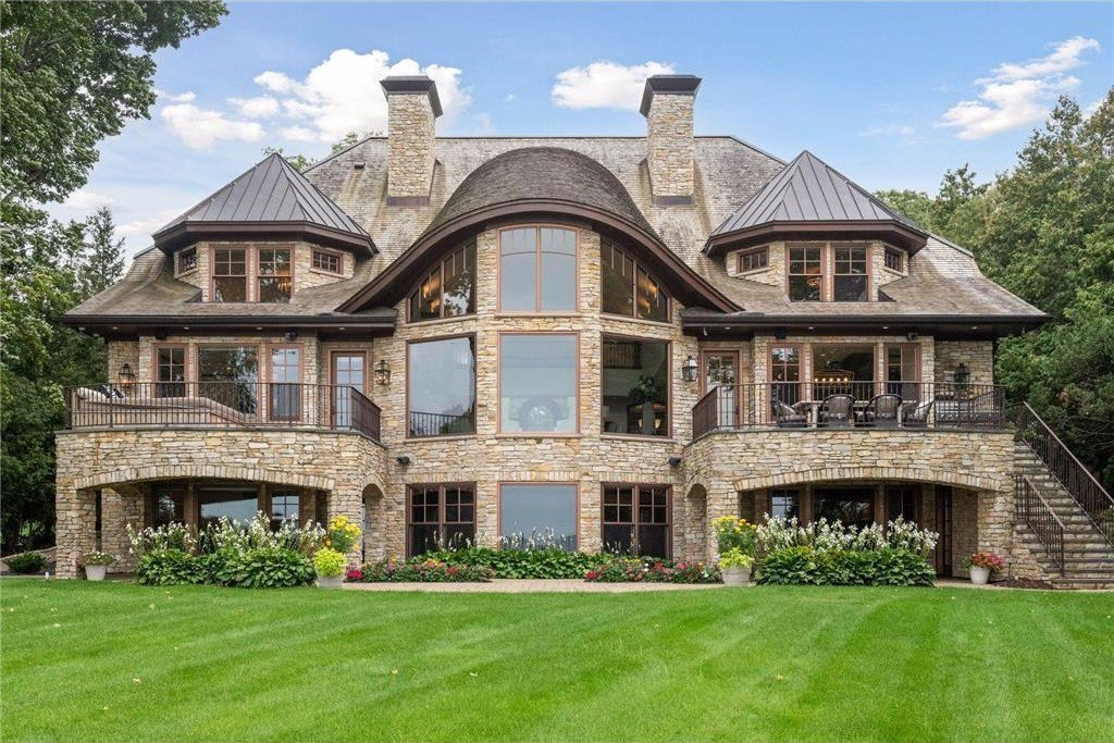 20630 Linwood Road Home in Excelsior, Minnesota. Welcome to 20630 Linwood Road, an exquisite gated estate nestled on two acres in the heart of Cottagewood USA, boasting 134 feet of premium northwest-facing, sandy, level lakeshore on Lake Minnetonka.