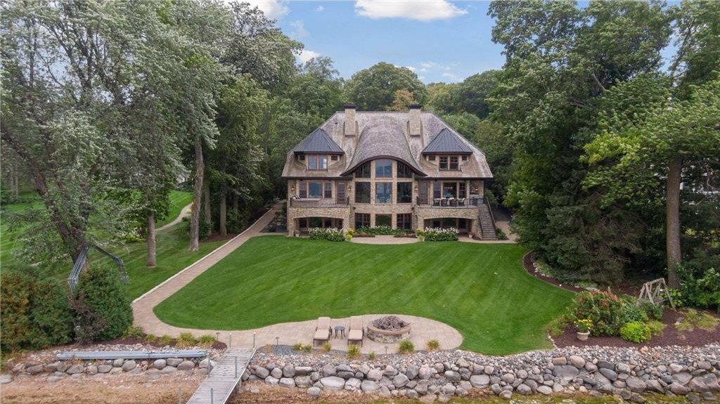 20630 Linwood Road Home in Excelsior, Minnesota. Welcome to 20630 Linwood Road, an exquisite gated estate nestled on two acres in the heart of Cottagewood USA, boasting 134 feet of premium northwest-facing, sandy, level lakeshore on Lake Minnetonka.