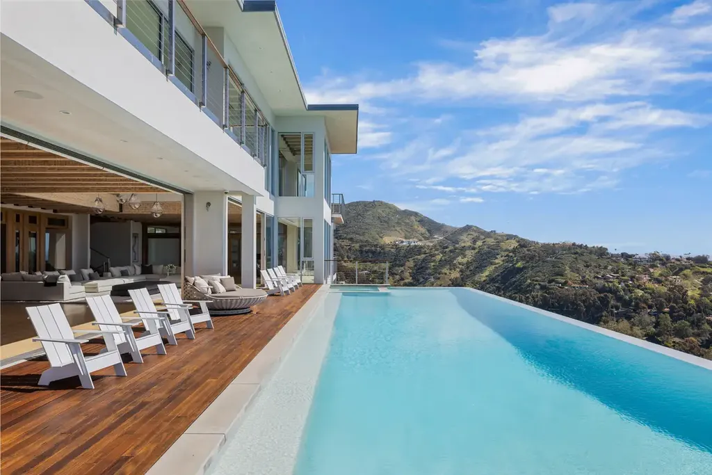 23800 Malibu Crest Drive Home in Malibu, California. Experience the pinnacle of coastal living in this new construction estate on a 3.4-acre promontory in Malibu. With breathtaking ocean, mountain, and canyon views, this 16,500-SF compound features a main house and guest house with luxurious amenities, including a Bulthaup chef's kitchen, infinity pool, and spa. 