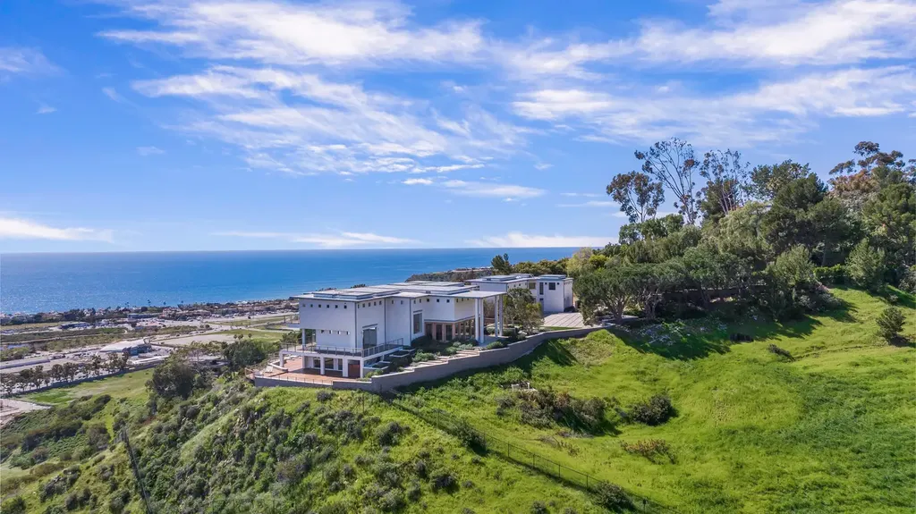 23800 Malibu Crest Drive Home in Malibu, California. Experience the pinnacle of coastal living in this new construction estate on a 3.4-acre promontory in Malibu. With breathtaking ocean, mountain, and canyon views, this 16,500-SF compound features a main house and guest house with luxurious amenities, including a Bulthaup chef's kitchen, infinity pool, and spa. 