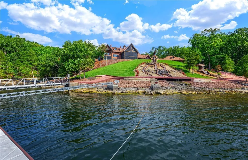 25 Springridge Lane Home in Sunrise Beach, Missouri. Experience the epitome of luxury at The Villages at Shawnee Bend, Lake of the Ozarks' most exclusive home development. This stunning estate, located in Billionaire’s Cove, is a one-of-a-kind masterpiece. Set on over 13 acres with 600+ feet of shoreline, it offers panoramic main channel views while nestled in a deepwater cove for dock protection and privacy.