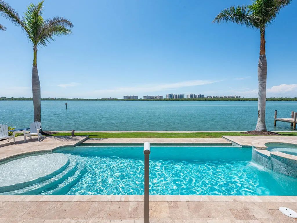 Nestled in prestigious Collier Bay on Marco Island, 960 Giralda Ct embodies coastal luxury living at its finest. With unobstructed bay views, this 2014-built, 4-bedroom, 5-bathroom home seamlessly combines opulence and coastal chic style.