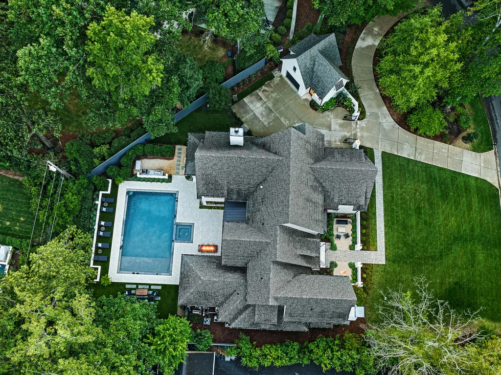 4000 Columbine Circle Home in Charlotte, North Carolina. Discover exquisite luxury living in this custom 5-bedroom, 5.5-bathroom home located in the desirable Foxcroft neighborhood. This David DuBose-designed residence features a gourmet kitchen, light-filled rooms with floor-to-ceiling windows, a spacious primary suite with a large closet, and a beautiful outdoor living space with a pool, spa, and detached garage with a flex space above.