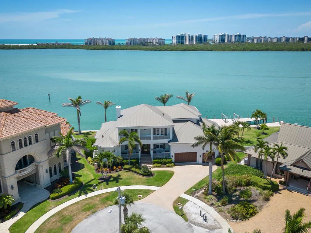 Nestled in prestigious Collier Bay on Marco Island, 960 Giralda Ct embodies coastal luxury living at its finest. With unobstructed bay views, this 2014-built, 4-bedroom, 5-bathroom home seamlessly combines opulence and coastal chic style.