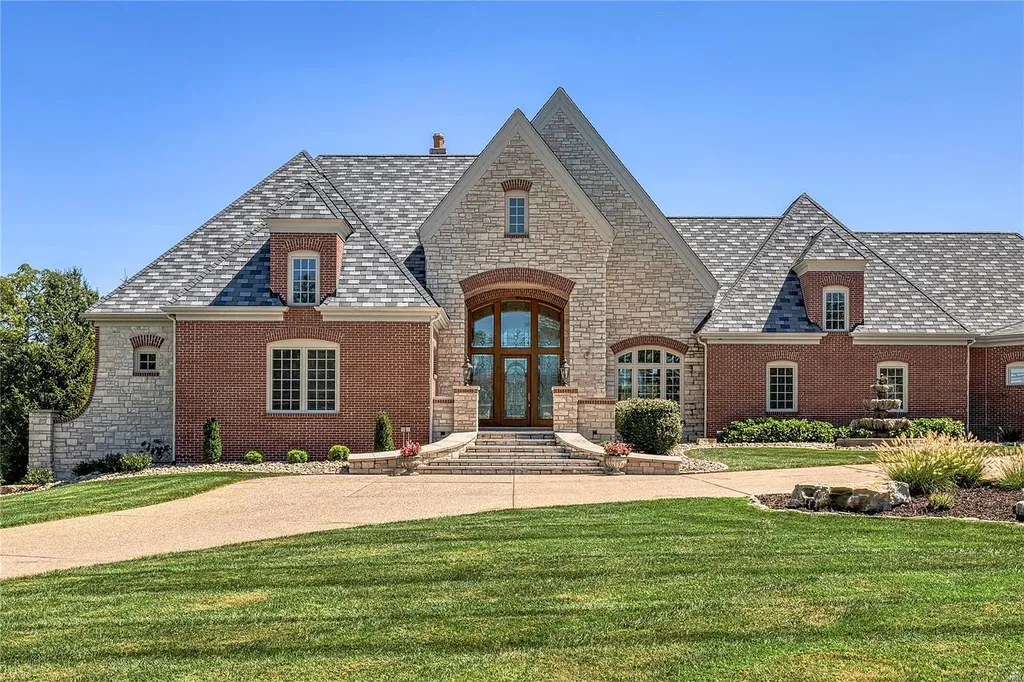 494 Rosslare Drive Home in Weldon Spring, Missouri. Step into the world of luxury with this spectacular estate home crafted by award-winning builder J L Wise. The artisan-crafted leaded glass entrance sets the tone as you enter the 2-story foyer, which leads to a formal dining room framed by arched entryways and architectural columns. The stunning great room features a floor-to-ceiling cast stone fireplace and expansive windows that offer breathtaking views of the 17th hole on the South course.