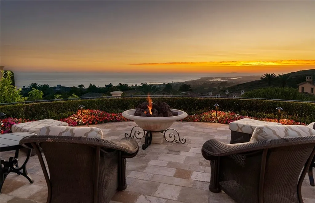 5 Pelicans Drive Home in Newport Coast, California. This stunning Pelican Crest estate is ideally located on one of the most coveted prime view lots in the community. It offers luxury and elegance along with warm and inviting living. The property has 6 bedrooms, 6.5 bathrooms, and a spacious floor plan that is perfect for both intimate living and entertaining. It also features stunning ocean views, a state-of-the-art theater, and a wine cellar.