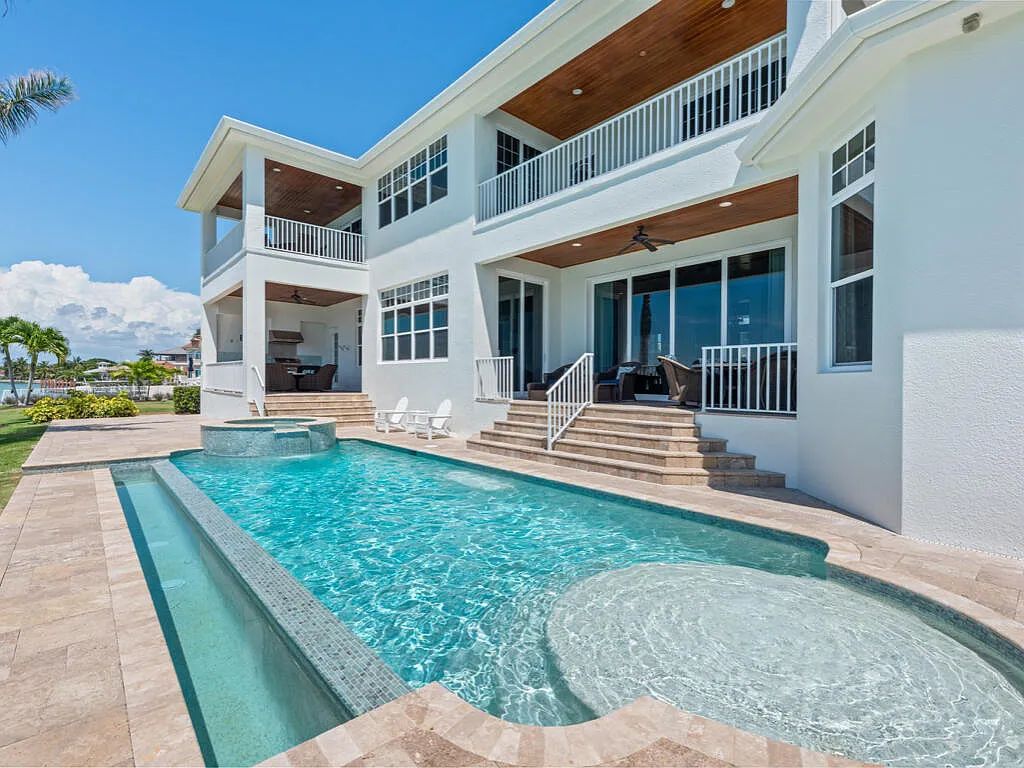 Nestled in prestigious Collier Bay on Marco Island, 960 Giralda Ct embodies coastal luxury living at its finest. With unobstructed bay views, this 2014-built, 4-bedroom, 5-bathroom home seamlessly combines opulence and coastal chic style.