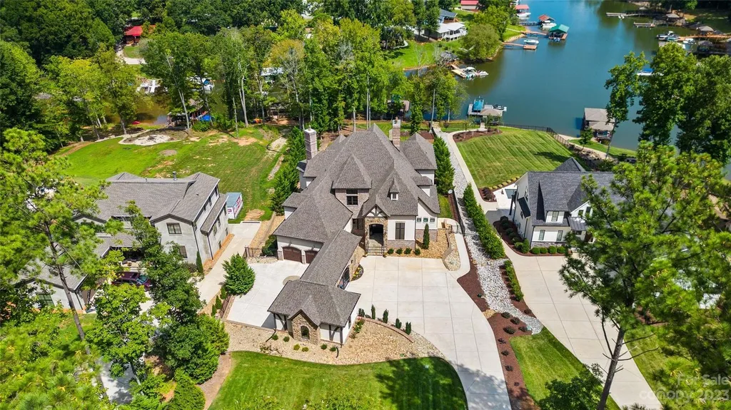 6907 Kingfisher Court Home in Denver, North Carolina. Escape to your own private oasis in this stunning luxury waterfront home located on the picturesque shores of Lake Norman. This home features a grand two story foyer and great room with floor-to-ceiling windows, a gourmet kitchen with top of the line appliances, a luxurious primary suite on the main level, an oversized patio and pool deck, and a private dock.