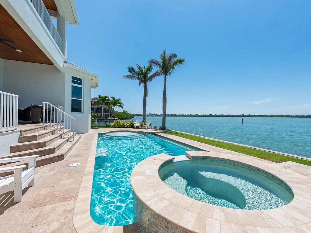 Nestled in prestigious Collier Bay on Marco Island, 960 Giralda Ct embodies coastal luxury living at its finest. With unobstructed bay views, this 2014-built, 4-bedroom, 5-bathroom home seamlessly combines opulence and coastal chic style.