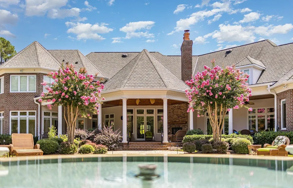 7728 Grace Cove Lane Home in Wake Forest, North Carolina. Discover this sprawling 31-acre estate featuring an exquisite all-brick home with custom features throughout. From reclaimed hardwoods to radiant heat flooring, this property exudes luxury. 