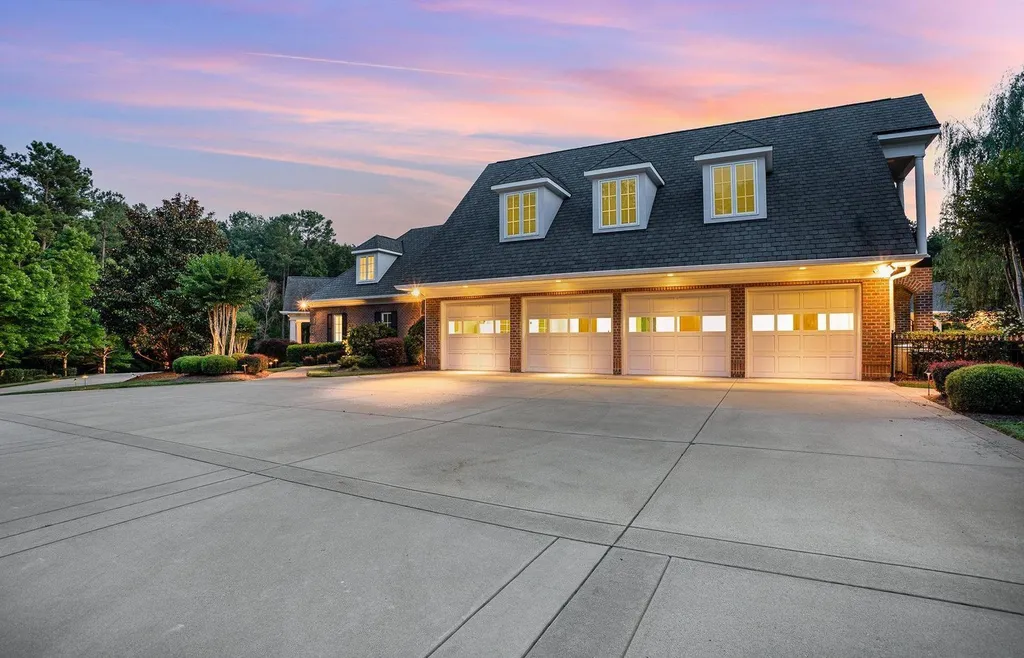 7728 Grace Cove Lane Home in Wake Forest, North Carolina. Discover this sprawling 31-acre estate featuring an exquisite all-brick home with custom features throughout. From reclaimed hardwoods to radiant heat flooring, this property exudes luxury. 