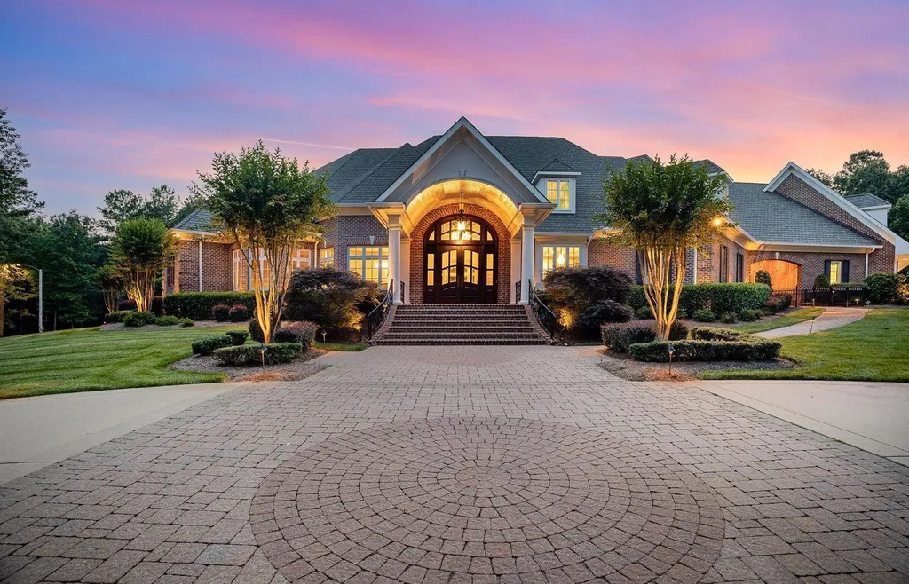 7728 Grace Cove Lane Home in Wake Forest, North Carolina. Discover this sprawling 31-acre estate featuring an exquisite all-brick home with custom features throughout. From reclaimed hardwoods to radiant heat flooring, this property exudes luxury. 