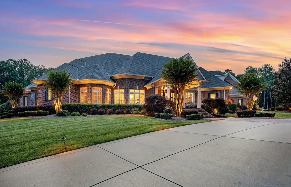 7728 Grace Cove Lane Home in Wake Forest, North Carolina. Discover this sprawling 31-acre estate featuring an exquisite all-brick home with custom features throughout. From reclaimed hardwoods to radiant heat flooring, this property exudes luxury. 