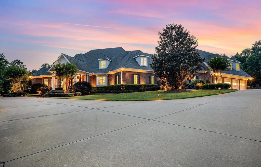 7728 Grace Cove Lane Home in Wake Forest, North Carolina. Discover this sprawling 31-acre estate featuring an exquisite all-brick home with custom features throughout. From reclaimed hardwoods to radiant heat flooring, this property exudes luxury. 