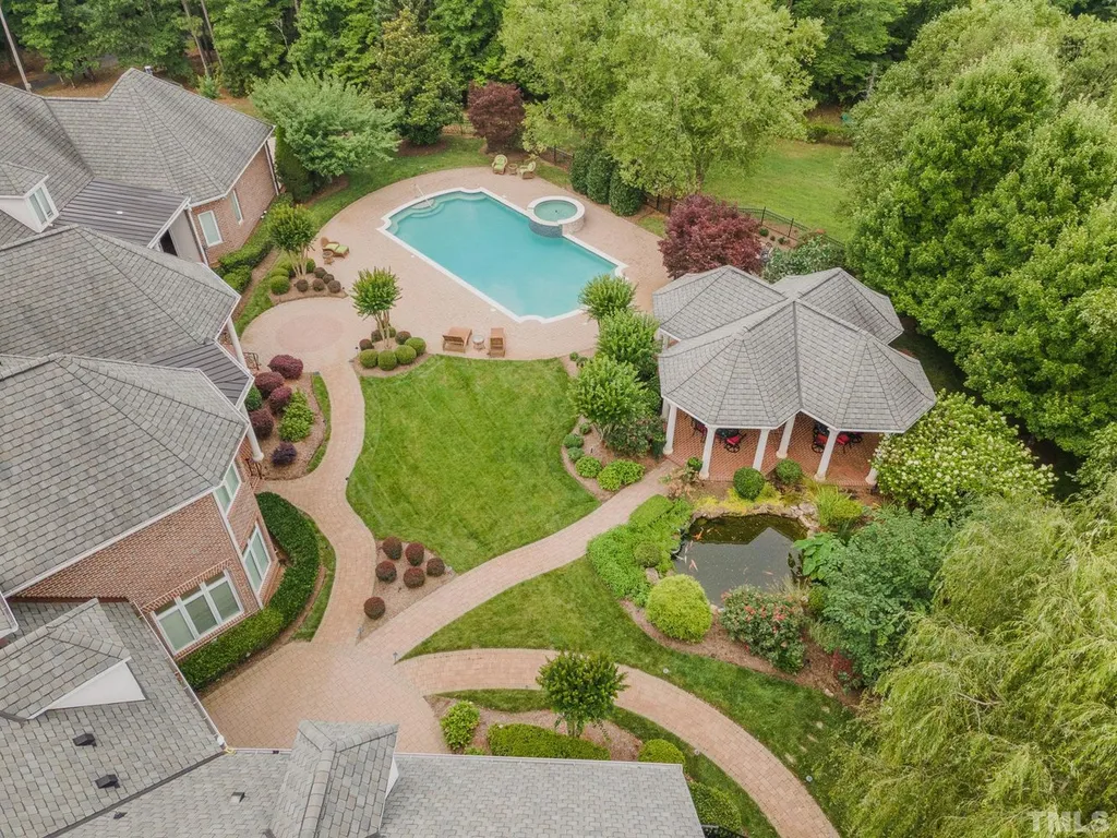 7728 Grace Cove Lane Home in Wake Forest, North Carolina. Discover this sprawling 31-acre estate featuring an exquisite all-brick home with custom features throughout. From reclaimed hardwoods to radiant heat flooring, this property exudes luxury. 