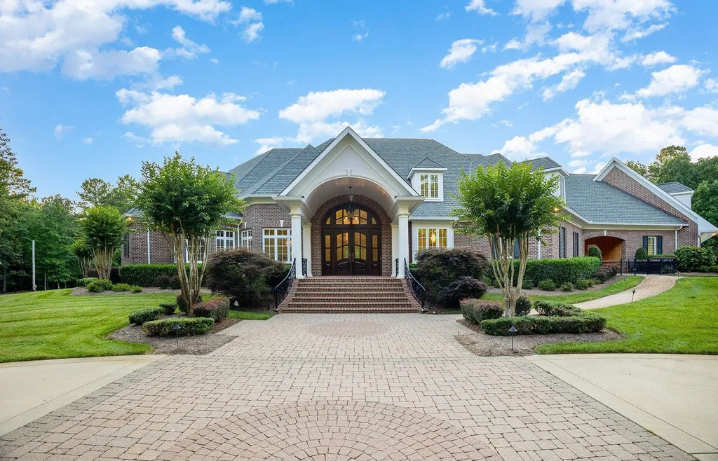 7728 Grace Cove Lane Home in Wake Forest, North Carolina. Discover this sprawling 31-acre estate featuring an exquisite all-brick home with custom features throughout. From reclaimed hardwoods to radiant heat flooring, this property exudes luxury. 