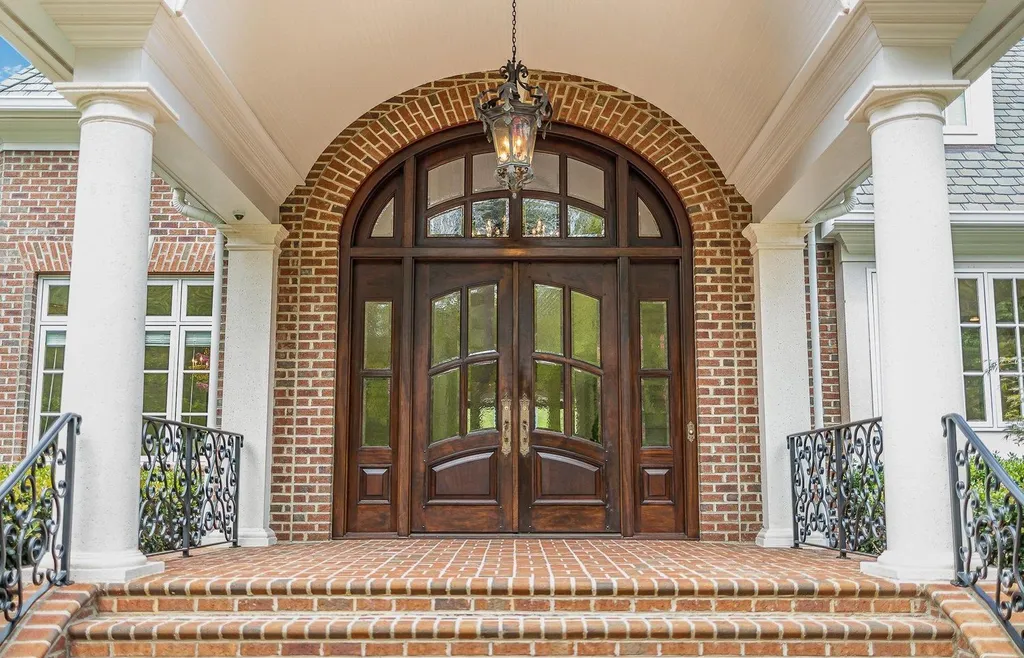 7728 Grace Cove Lane Home in Wake Forest, North Carolina. Discover this sprawling 31-acre estate featuring an exquisite all-brick home with custom features throughout. From reclaimed hardwoods to radiant heat flooring, this property exudes luxury. 