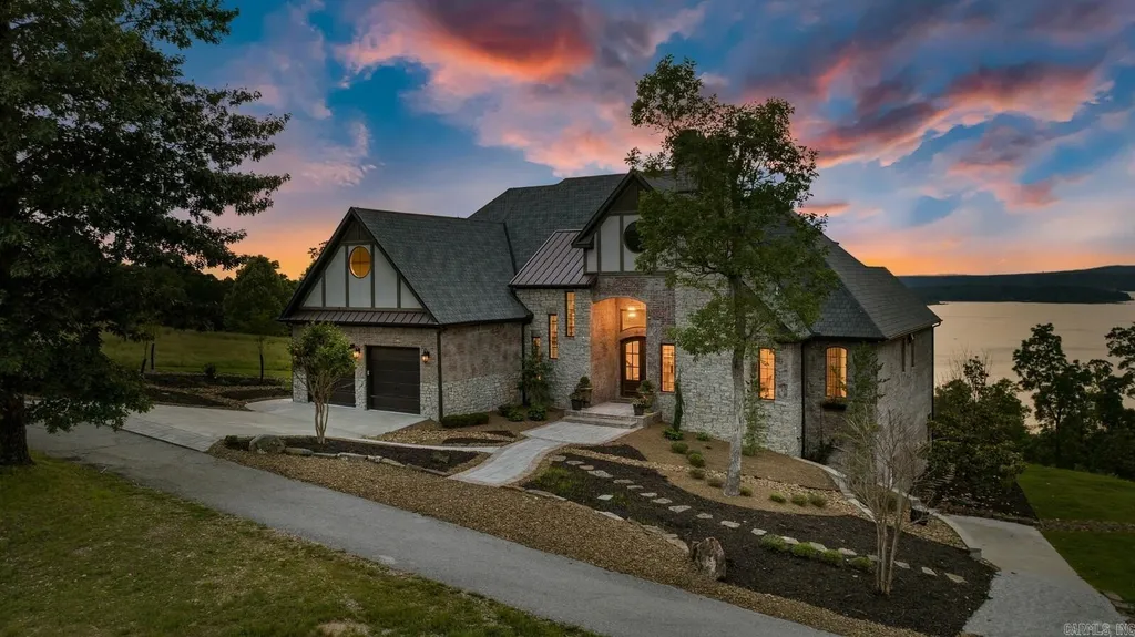 8919 Castleberry Way Home in Rogers, Arkansas. Discover the epitome of luxury living on a sought-after .97-acre lot with breathtaking Beaver Lake views. This custom-built home is a masterpiece, boasting meticulously landscaped grounds and thoughtfully designed spaces for both formal and casual living. 