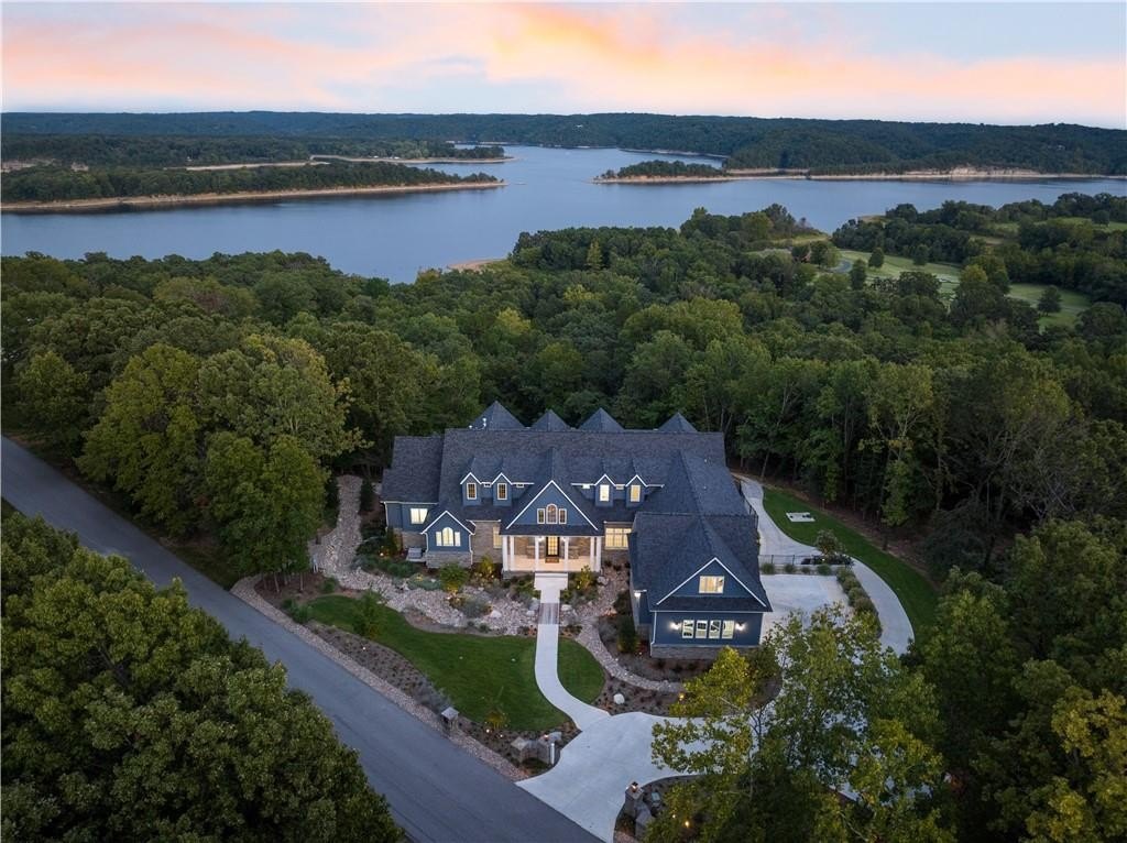 9966 Old Campbell Road Home in Rogers, Arkansas. Prepare to be captivated by this extraordinary 5-bedroom, 6.5-bathroom, 8,321 sqft estate, nestled on 6 acres in Rogers. It includes ownership of TWO slips in a co-owned boat dock, granting exclusive access to pristine Beaver Lake.
