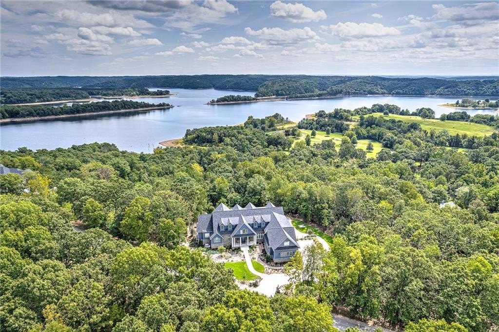 9966 Old Campbell Road Home in Rogers, Arkansas. Prepare to be captivated by this extraordinary 5-bedroom, 6.5-bathroom, 8,321 sqft estate, nestled on 6 acres in Rogers. It includes ownership of TWO slips in a co-owned boat dock, granting exclusive access to pristine Beaver Lake.