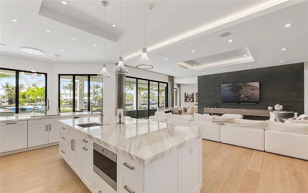 Discover the epitome of luxury in this contemporary Lighthouse Point home with 6 bedrooms, 7 bathrooms, and 6,318 square feet of living space, built in 2019. Perfectly designed for yachtsmen, it offers 243 feet of deep water access just minutes from Hillsboro Inlet.