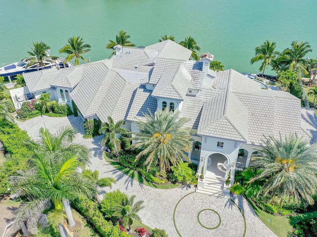 Discover your dream home at 1340 Caxambas Ct, Marco Island, Florida! This 5-bed, 5-bath luxury residence with a theater room boasts 5,007 sq ft of impeccable craftsmanship, situated on 0.59 acres with 248 ft of water frontage and a newer seawall, ensuring endless views and quick access to Caxambas Pass.