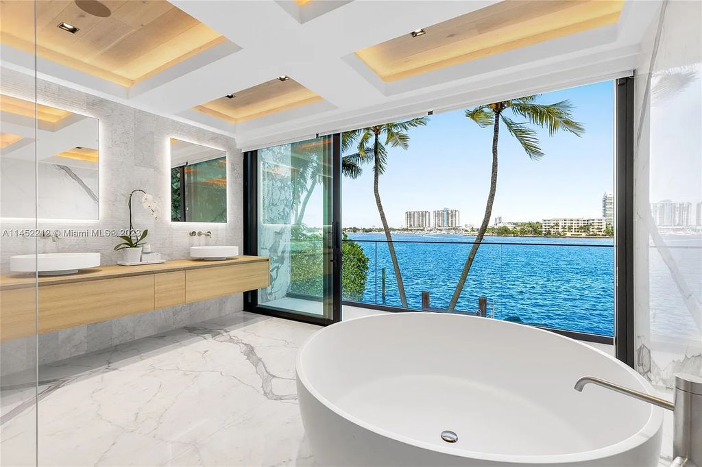 Step into the epitome of modern luxury at 247 E Rivo Alto Dr, a 6-bedroom, 7-bathroom waterfront estate on the Venetian Islands. Meticulously crafted in 2021, this contemporary masterpiece boasts vibrant marbles, an open-plan living area, a chic cocktail bar, sculptural staircases, and a chef's dream kitchen with Gaggenau appliances.