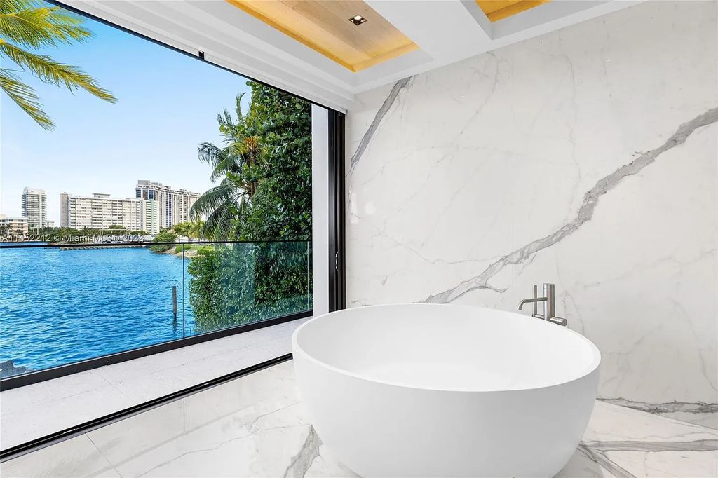 Step into the epitome of modern luxury at 247 E Rivo Alto Dr, a 6-bedroom, 7-bathroom waterfront estate on the Venetian Islands. Meticulously crafted in 2021, this contemporary masterpiece boasts vibrant marbles, an open-plan living area, a chic cocktail bar, sculptural staircases, and a chef's dream kitchen with Gaggenau appliances.