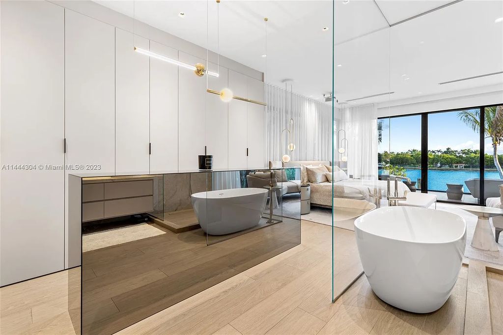 Experience the epitome of Miami Beach luxury living at 250 S Hibiscus Drive. This immaculate 4-bed, 4-bath waterfront home boasts a modern open-concept layout, bathed in natural light and adorned with high-end fixtures.