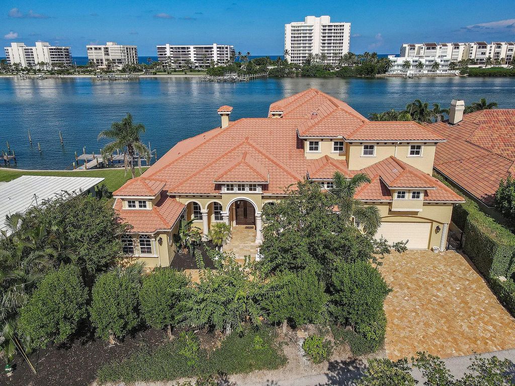 Discover unparalleled waterfront living at 19709 Harbor Road, Jupiter, Florida. This exquisite 3-bedroom, 4-bathroom estate, spanning 5,319 square feet on a 0.37-acre lot, presents breathtaking Intracoastal Waterway views.
