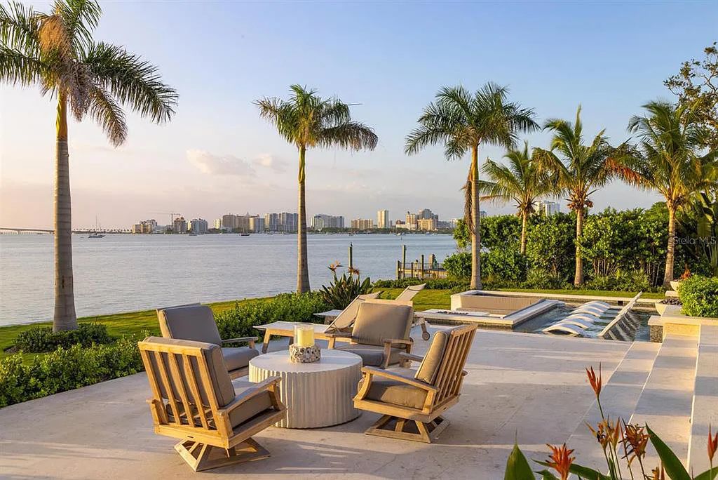 Nestled within Sarasota's Harbor Acres Estate Section, 1233 Hillview Drive is a masterful bayfront estate showcasing sophistication, craftsmanship, and technological excellence. This 8-bedroom, 12-bathroom British West Indies-style residence, built in 2022, spans 11,275 square feet on nearly an acre of land with 144 feet of bay frontage.