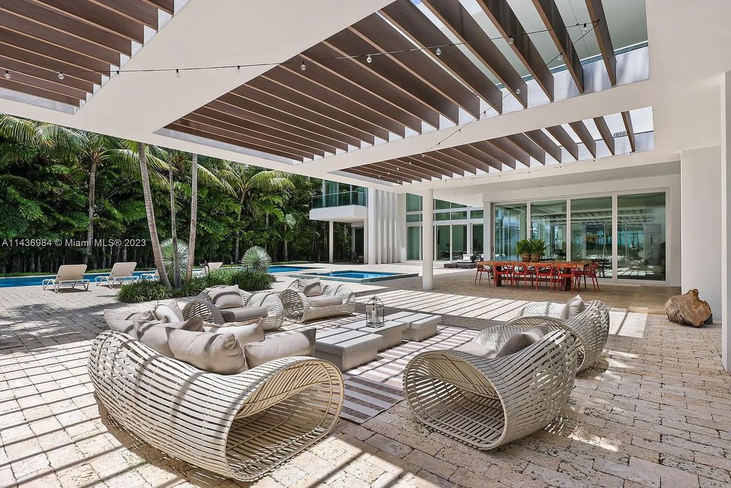 Experience unparalleled luxury at 30 Palm Ave, Miami Beach. This modern estate, nestled on Palm Island, boasts 9 bedrooms, 9.5 bathrooms, and 13,144 square feet of living space on a 32,000 square feet lot. Highlights include a gourmet kitchen with water views, a lavish primary suite with private balconies, and multiple outdoor spaces offering bay and skyline views.