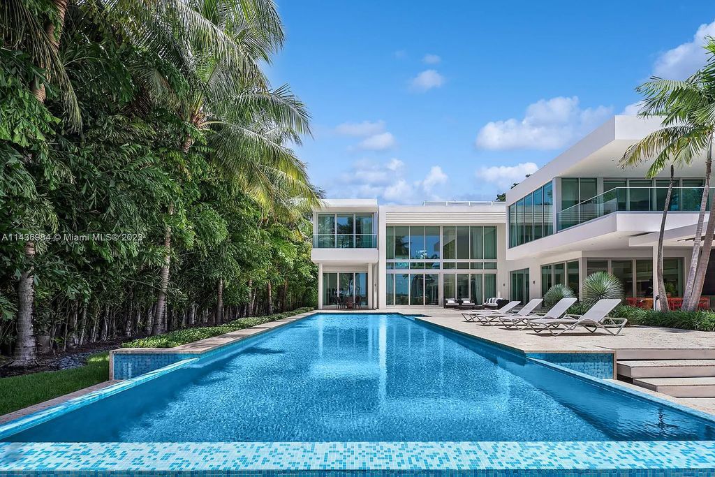 Experience unparalleled luxury at 30 Palm Ave, Miami Beach. This modern estate, nestled on Palm Island, boasts 9 bedrooms, 9.5 bathrooms, and 13,144 square feet of living space on a 32,000 square feet lot. Highlights include a gourmet kitchen with water views, a lavish primary suite with private balconies, and multiple outdoor spaces offering bay and skyline views.