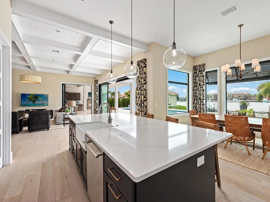 Discover waterfront perfection at 681 Crescent St, Marco Island, FL. This 2020-built, lightly lived-in masterpiece offers 4 bedrooms, 5 baths, and 4,047 square feet of luxury living. Its open split floor plan seamlessly blends indoor and outdoor spaces, revealing breathtaking bay views.