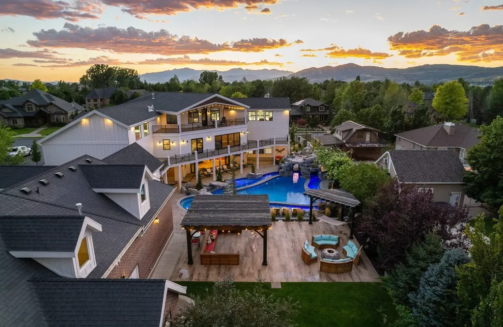 1263 East Chapman Court Home in Alpine, Utah. Step into the lap of luxury in this expansive 13,000 sq ft home in Alpine, Utah. With 8 oversized bedrooms, 6 bathrooms, a 13-car garage, and an outdoor entertainment paradise featuring a pool, spa, and lush landscaping, this property is perfect for hosting and living in grand style.