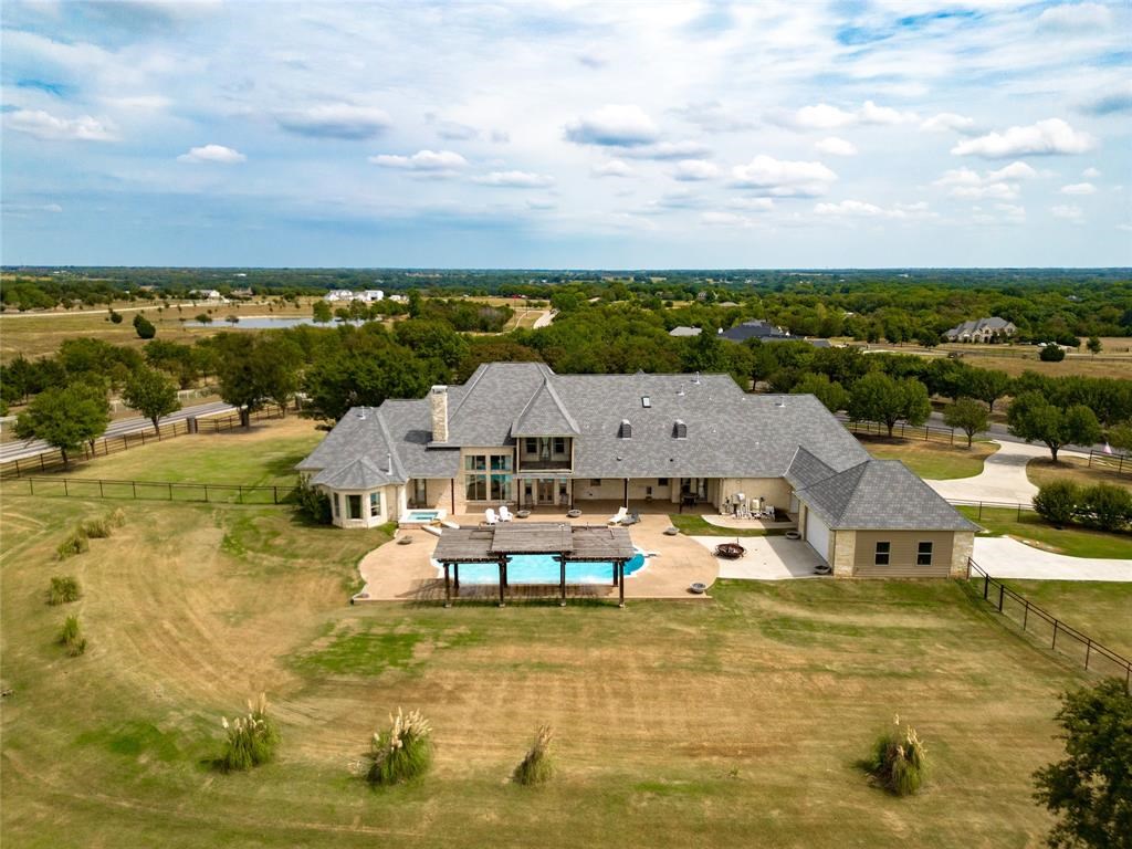 2933 North Star Drive Home in Celina, Texas. Discover the epitome of countryside luxury on nearly 4 acres, fully fenced for privacy. With 6 bedrooms, each boasting its own en-suite, and a 5-car garage doubling as an entertaining space, this home offers the ideal blend of comfort and grandeur.