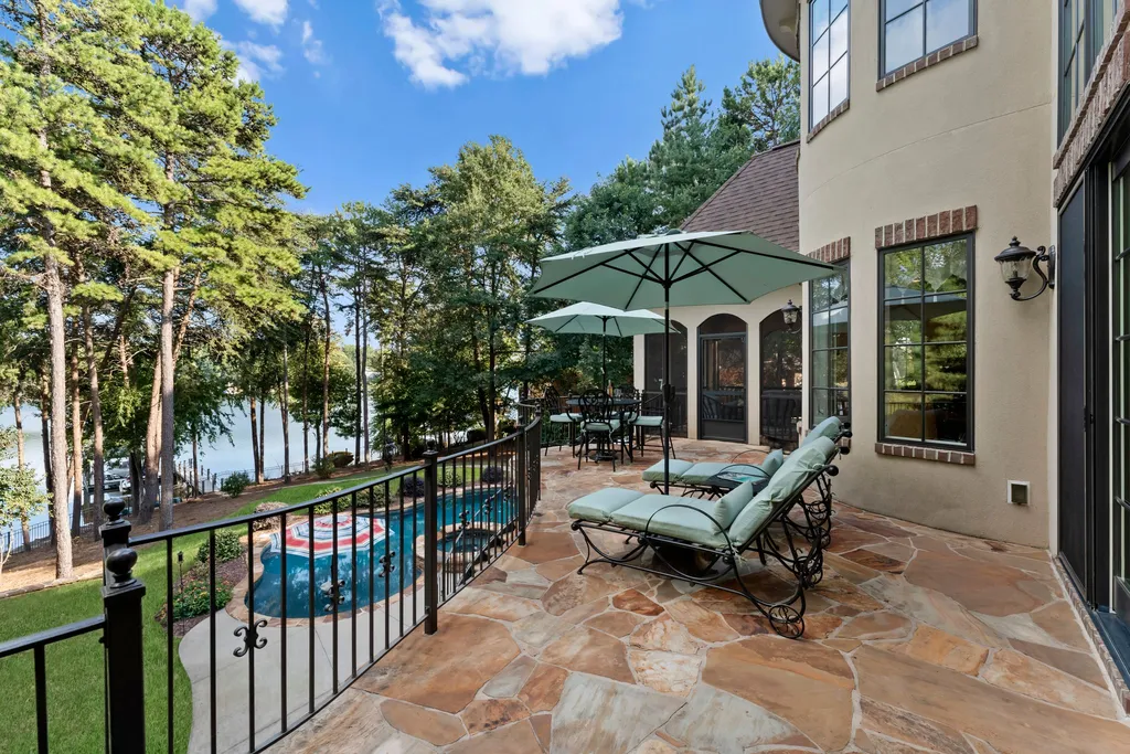 413 Bay Harbour Road Home in Mooresville, North Carolina. This stunning custom-built waterfront home on Lake Norman features luxurious amenities, including mahogany doors, a two-story great room, high-end kitchen, primary suite, and a private office. 