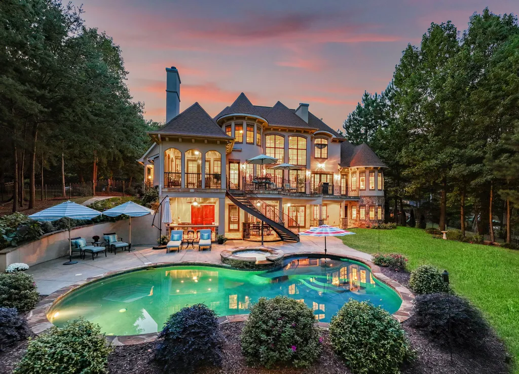 413 Bay Harbour Road Home in Mooresville, North Carolina. This stunning custom-built waterfront home on Lake Norman features luxurious amenities, including mahogany doors, a two-story great room, high-end kitchen, primary suite, and a private office. 